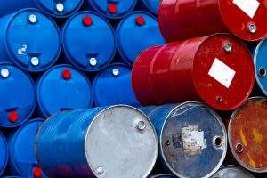 A massive stockpile of blue and red industrial drums, representing the safe and compliant waste transportation and hazardous waste management of chemical, oil, and liquid materials.